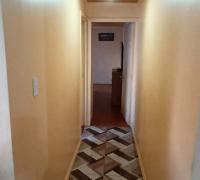 PASILLO QUE CONECTA LIVING COMEDOR HACIA HABITACION MULTIUSO Y DORMITORIO PRINCIPAL EN SUIT