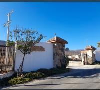  Se encuentra edificada una vivienda estilo "mediterránea" de un nivel  de altura, de agrupación aislada de 231,47m2 de superficie, construida en base a estructura de muros y techumbre de metalcon, terminación  exterior en base a pintura sobre estuco y cubierta de zink. Como obra complementaría asocia cierre perimetral, portón de acceso eléctrico,  cobertizo, piscina, una bodega y un canil. Cuenta con 70 especies de árboles frutales, sistema de reutilización de aguas grises, riego automático. El   predio cu