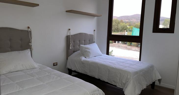 segundo dormitorio con dos camas, clóset.
